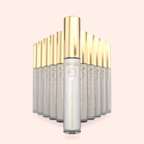 Multiple skincare bottles  of Brow Daddy VANILÁMI Brow Styling Aftercare with gold caps on a light pink background