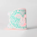 A face contouring device by Omnilux, featuring a white body with a mint green floral pattern and pink accents, shown on a light gray background.