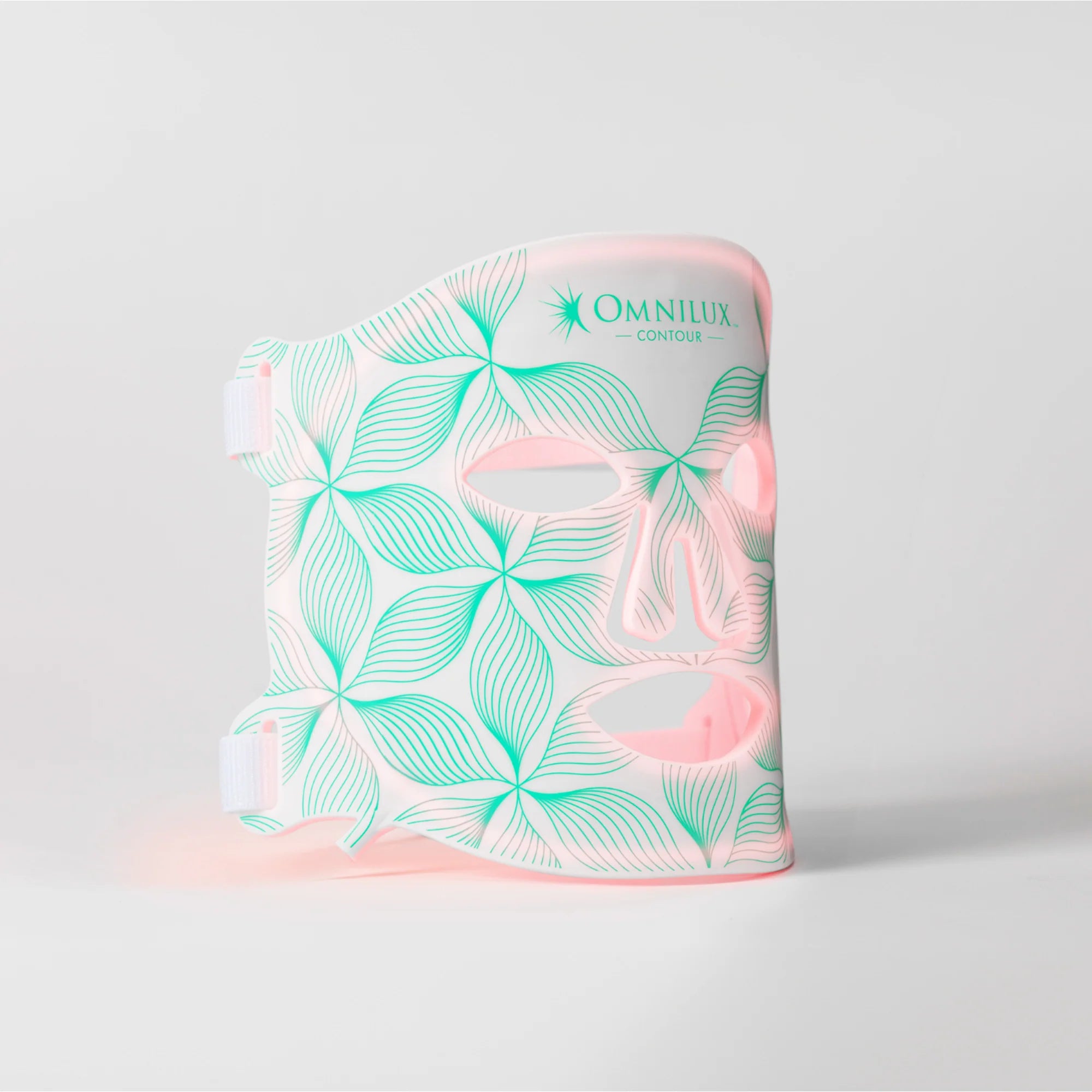 A face contouring device by Omnilux, featuring a white body with a mint green floral pattern and pink accents, shown on a light gray background.