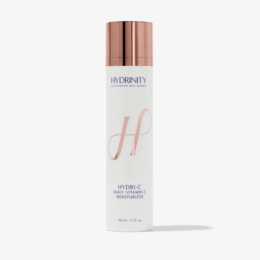 Skincare bottle with rose gold cap and white label on a light gray background