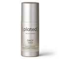 Silver skincare serum bottle labeled 'plated' on a white background